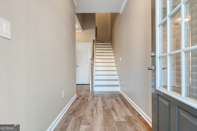 145 Sunset Ln, Woodstock, GA 30189 - staircase with wood finished floors, baseboards, and crown molding