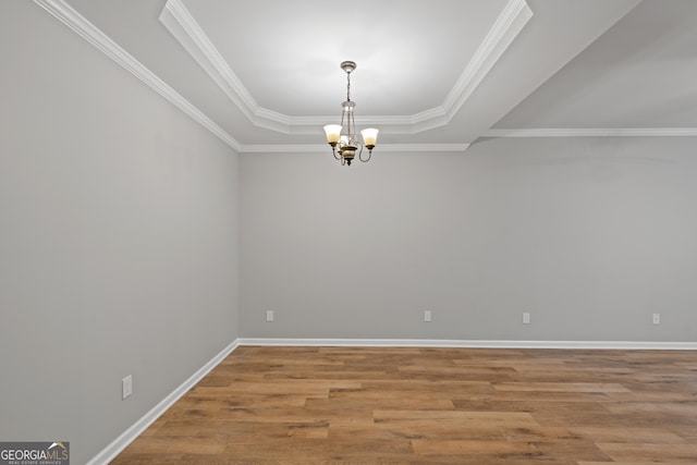 145 Sunset Ln, Woodstock, GA 30189 - unfurnished room with a chandelier, a tray ceiling, wood finished floors, baseboards, and ornamental molding