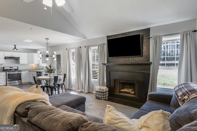 4419 White Rd, Douglasville, GA 30135 - living area with a textured ceiling, a large fireplace, ceiling fan with notable chandelier, vaulted ceiling, and light colored carpet