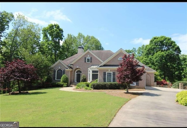 8155 Legends View Ct, Cumming, GA 30028 - view of front facade with a front lawn, a chimney, driveway, and brick siding