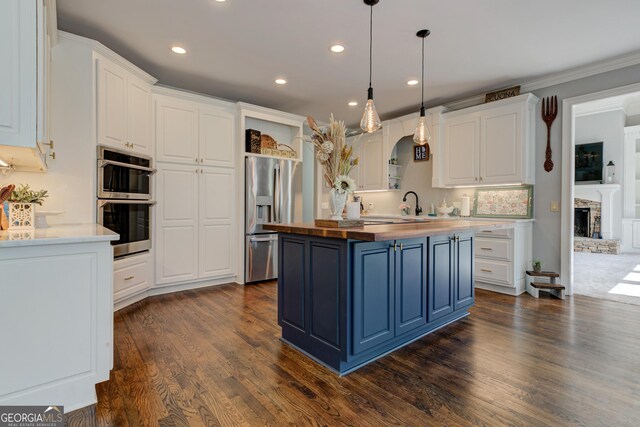 8155 Legends View Ct, Cumming, GA 30028 - kitchen featuring butcher block counters, stainless steel appliances, white cabinetry, blue cabinets, and recessed lighting