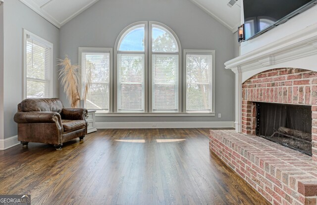 8155 Legends View Ct, Cumming, GA 30028 - sitting room featuring lofted ceiling, baseboards, a fireplace, and wood finished floors