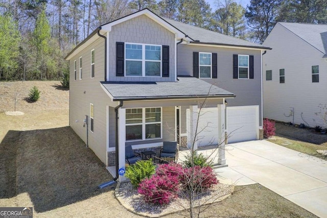 221 Sullivan St, Hampton, GA 30228 - view of front of house featuring stone siding, an attached garage, roof with shingles, driveway, and covered porch