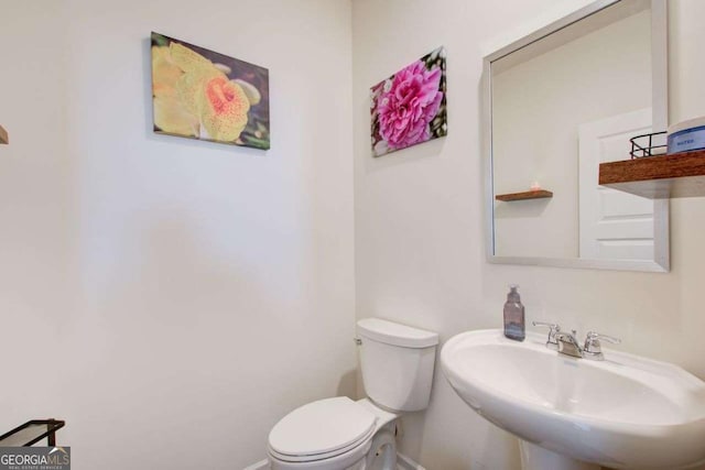 221 Sullivan St, Hampton, GA 30228 - half bath with toilet, a sink, and baseboards
