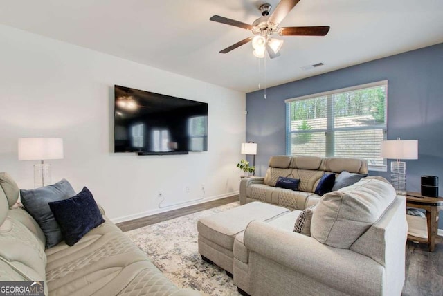221 Sullivan St, Hampton, GA 30228 - living room featuring a ceiling fan, wood finished floors, baseboards, and visible vents