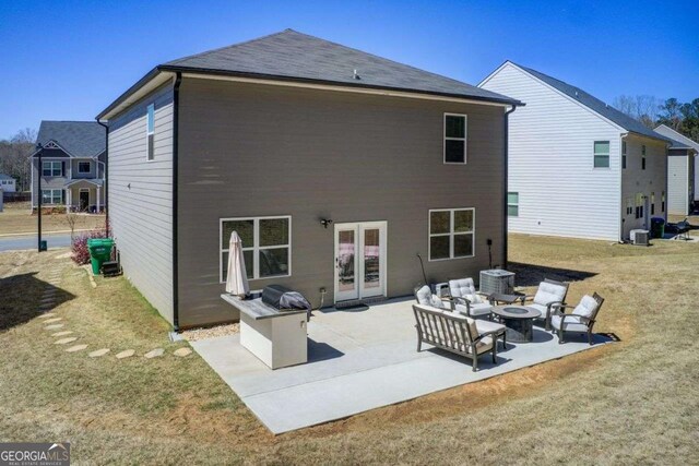 221 Sullivan St, Hampton, GA 30228 - back of property with an outdoor fire pit, french doors, a yard, and a patio area