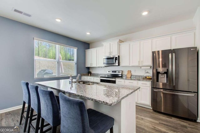 221 Sullivan St, Hampton, GA 30228 - kitchen with white cabinetry, a sink, stainless steel appliances, and visible vents