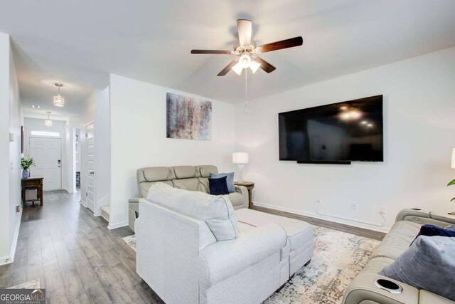 221 Sullivan St, Hampton, GA 30228 - living room featuring baseboards, wood finished floors, and a ceiling fan