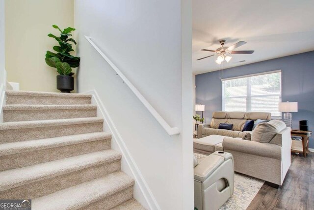 221 Sullivan St, Hampton, GA 30228 - stairway featuring baseboards, wood finished floors, and a ceiling fan