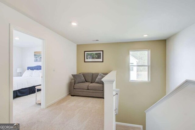 221 Sullivan St, Hampton, GA 30228 - living area featuring an upstairs landing, light carpet, baseboards, visible vents, and recessed lighting