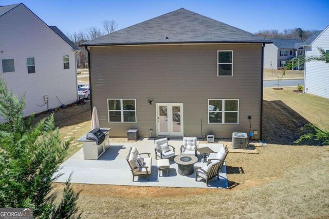 221 Sullivan St, Hampton, GA 30228 - back of house featuring an outdoor fire pit, cooling unit, a patio, and a lawn