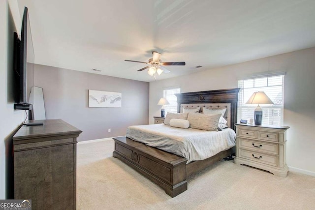 221 Sullivan St, Hampton, GA 30228 - bedroom with light colored carpet, visible vents, baseboards, and a ceiling fan