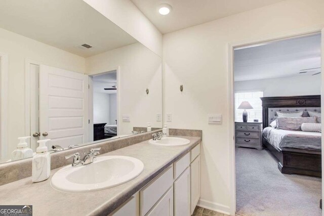 221 Sullivan St, Hampton, GA 30228 - ensuite bathroom with double vanity, a sink, baseboards, and ensuite bathroom