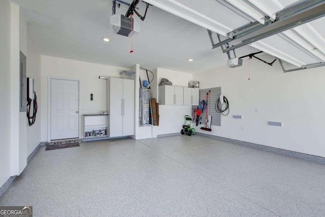 221 Sullivan St, Hampton, GA 30228 - garage with water heater, baseboards, and a garage door opener