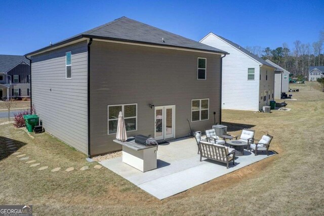 221 Sullivan St, Hampton, GA 30228 - back of property with an outdoor fire pit, a patio area, and a lawn