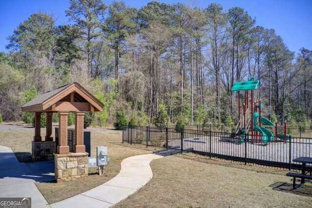 221 Sullivan St, Hampton, GA 30228 - community jungle gym with fence and a view of trees