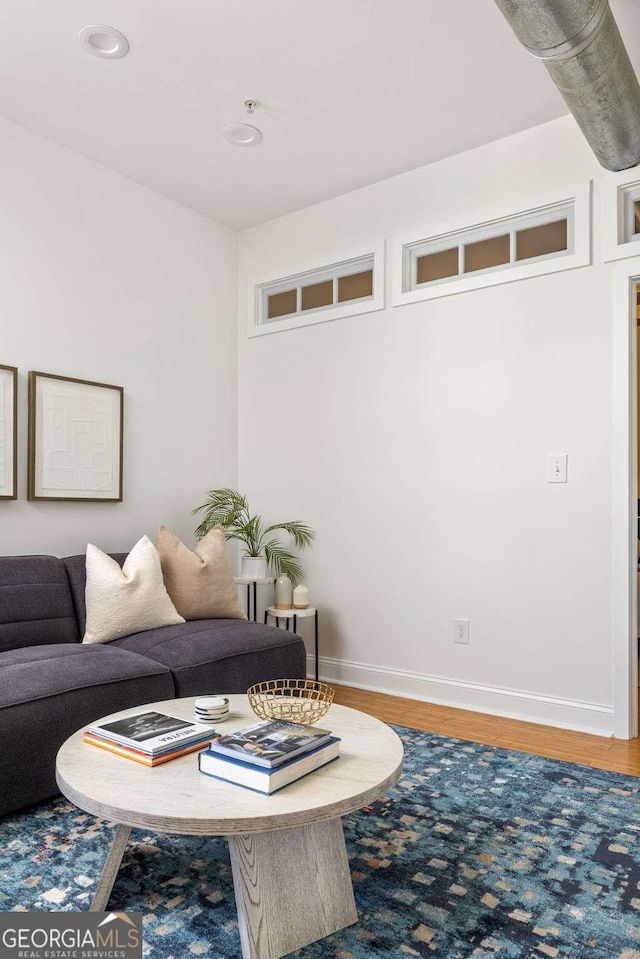living room with baseboards and wood finished floors