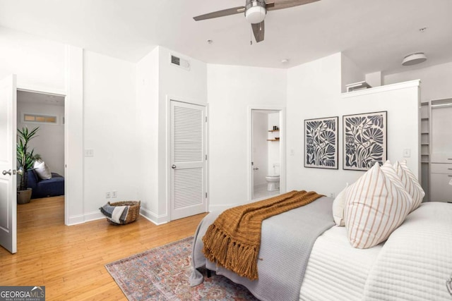 bedroom featuring light wood-style flooring, baseboards, connected bathroom, visible vents, and a ceiling fan