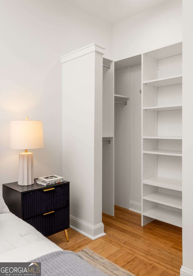 bedroom featuring baseboards and light wood-style floors