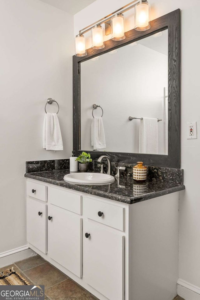 bathroom featuring baseboards and vanity
