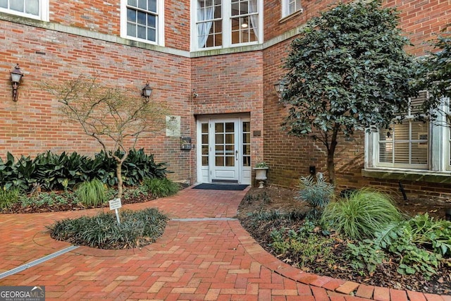 property entrance featuring brick siding