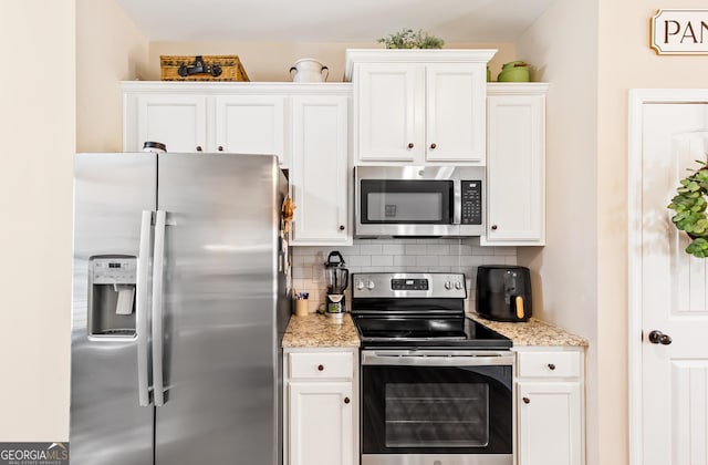 275 Cedars Glen Cir, Villa Rica, GA 30180 - kitchen with decorative backsplash, white cabinetry, and stainless steel appliances