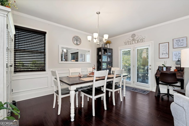 dining space with wood finished floors, an inviting chandelier, and crown molding