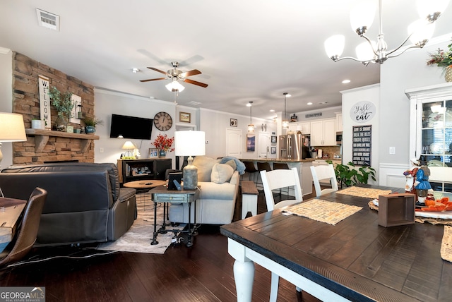dining space with recessed lighting, ornamental molding, ceiling fan with notable chandelier, dark wood-style floors, and visible vents