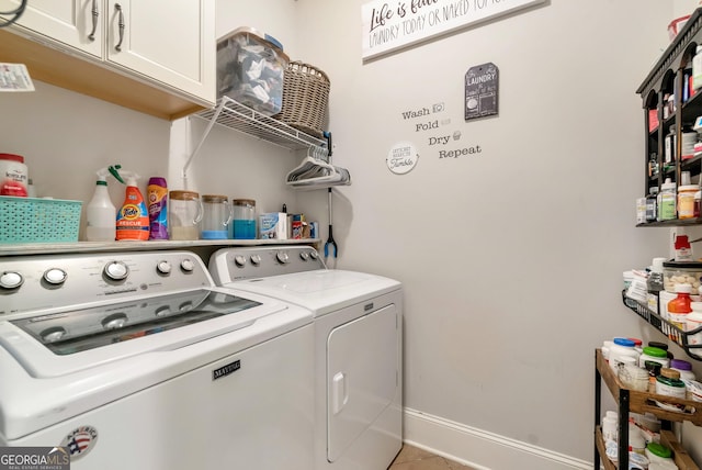 laundry room featuring baseboards, cabinet space, tile patterned flooring, and washing machine and dryer