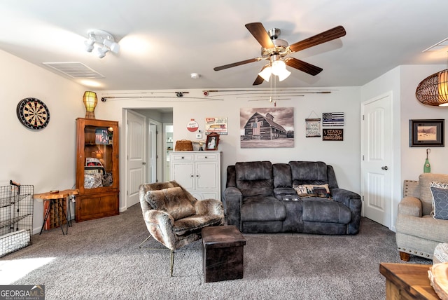 living area with visible vents, a ceiling fan, and carpet flooring