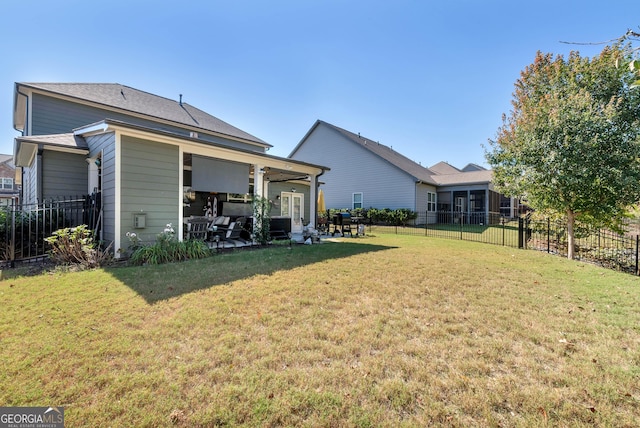 rear view of house featuring a fenced backyard, a yard, and a patio area
