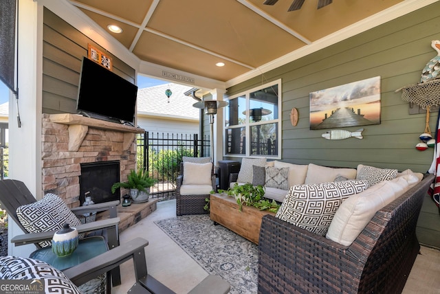view of patio / terrace with ceiling fan, fence, and an outdoor living space with a fireplace