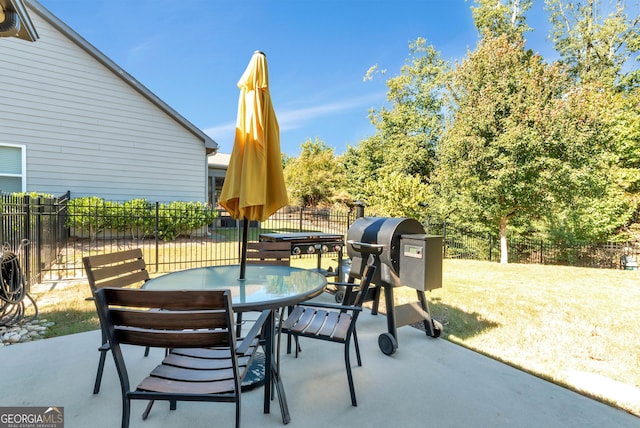 view of patio featuring fence and outdoor dining area