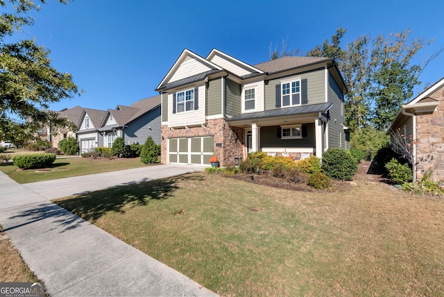 craftsman-style home with a standing seam roof, a garage, stone siding, a front yard, and concrete driveway