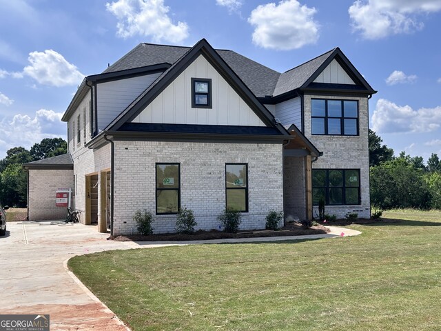 699 Rambler Inn Rd, Jefferson, GA 30549 - view of front of home with brick siding, a front lawn, and board and batten siding