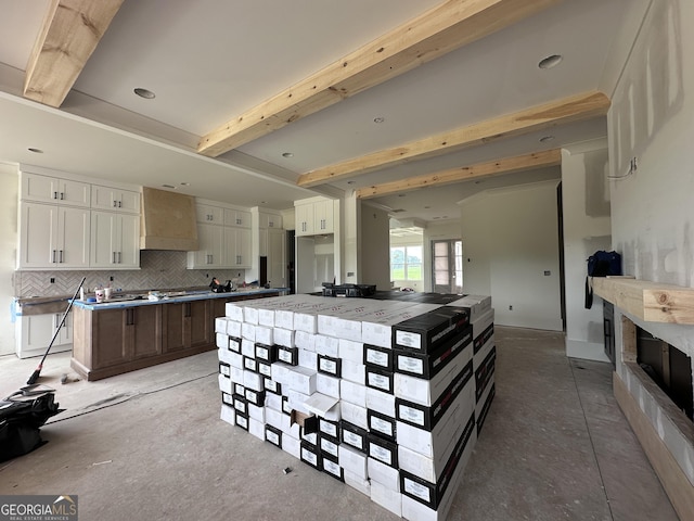 699 Rambler Inn Rd, Jefferson, GA 30549 - kitchen featuring premium range hood, tasteful backsplash, white cabinets, a center island, and beam ceiling