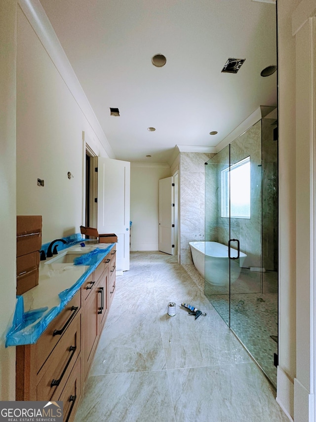699 Rambler Inn Rd, Jefferson, GA 30549 - bathroom with a freestanding bath, double vanity, ornamental molding, and a stall shower