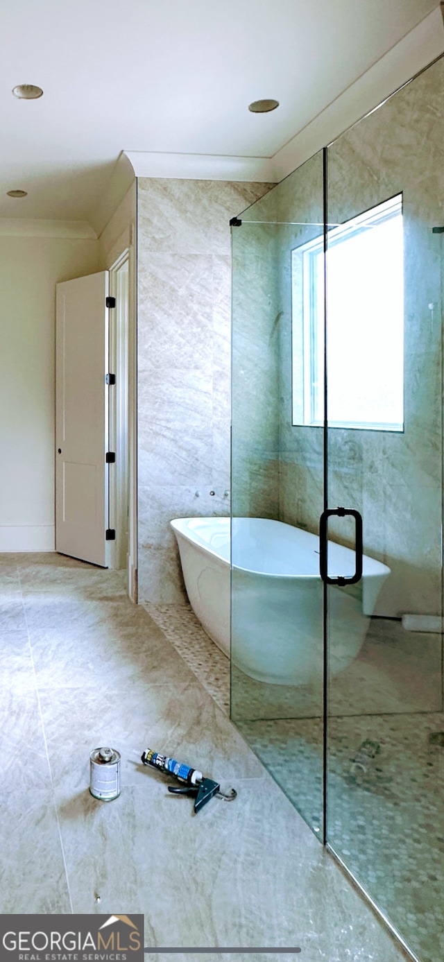 699 Rambler Inn Rd, Jefferson, GA 30549 - bathroom with a stall shower, a freestanding tub, and ornamental molding