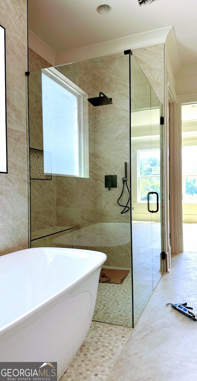 699 Rambler Inn Rd, Jefferson, GA 30549 - bathroom featuring tile walls, a freestanding bath, and a shower with door