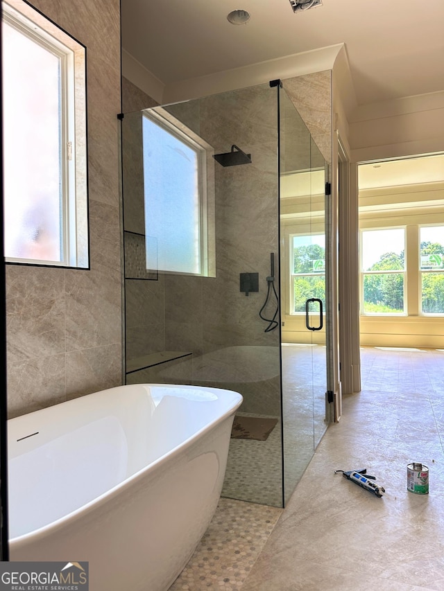 699 Rambler Inn Rd, Jefferson, GA 30549 - bathroom featuring tile walls, a freestanding tub, and a tile shower