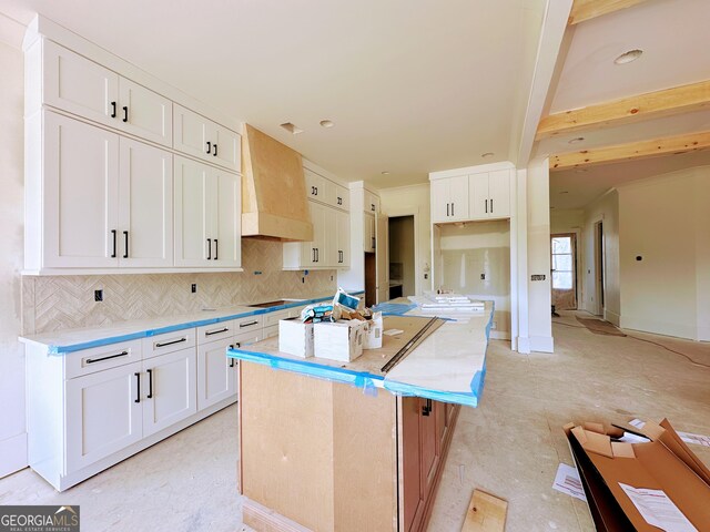 699 Rambler Inn Rd, Jefferson, GA 30549 - kitchen featuring premium range hood, a center island, backsplash, and white cabinetry