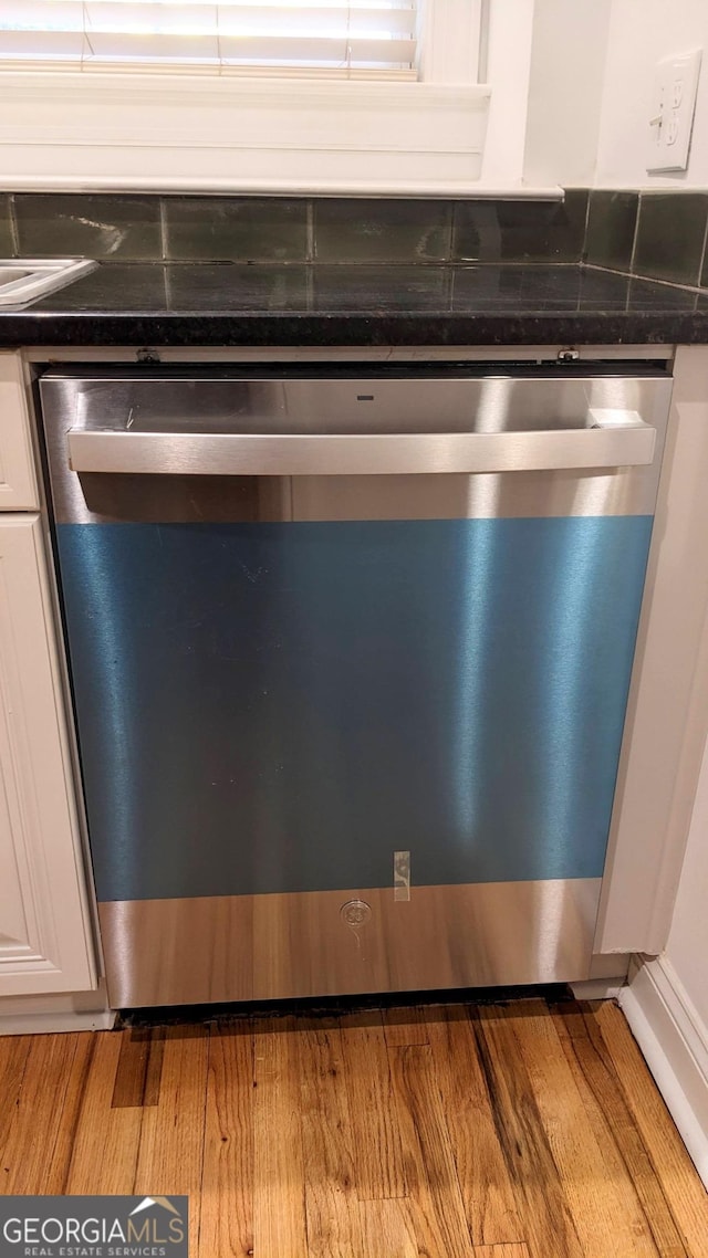 234 Carlyle Park Dr NE, Atlanta, GA 30307 - details featuring light wood-style floors, dark countertops, white cabinets, and dishwasher