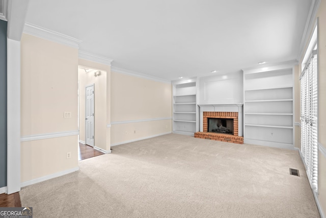 unfurnished living room with visible vents, ornamental molding, carpet floors, baseboards, and a fireplace