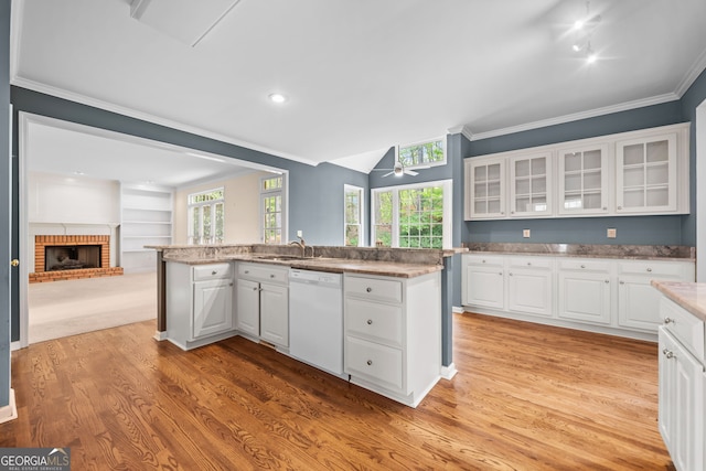 kitchen with white dishwasher, light wood-type flooring, and ornamental molding