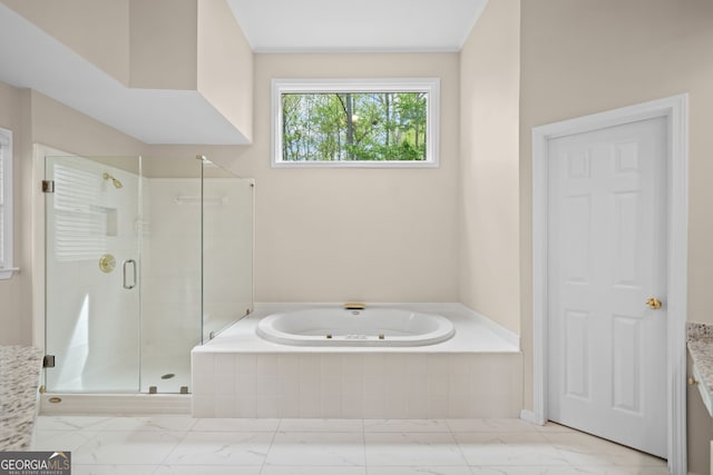 full bath with marble finish floor, a garden tub, and a stall shower