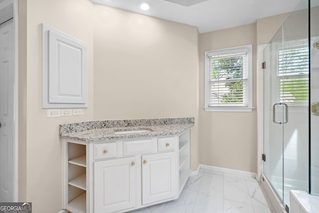 bathroom with baseboards, vanity, marble finish floor, and a shower stall
