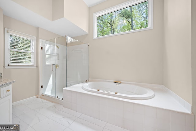 full bath featuring a bath, vanity, marble finish floor, and a shower stall