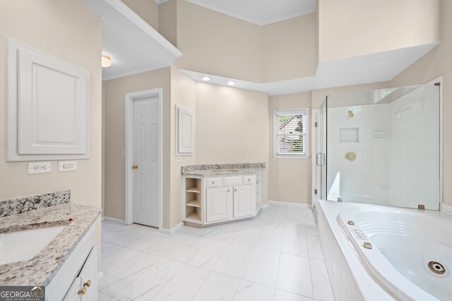 535 Woodbrook Way, Lawrenceville, GA 30043 - bathroom with two vanities, marble finish flooring, a whirlpool tub, a stall shower, and crown molding