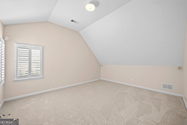 bonus room featuring baseboards, vaulted ceiling, visible vents, and carpet
