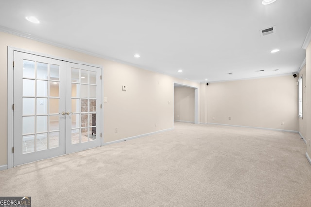 interior space with light carpet, crown molding, french doors, and visible vents